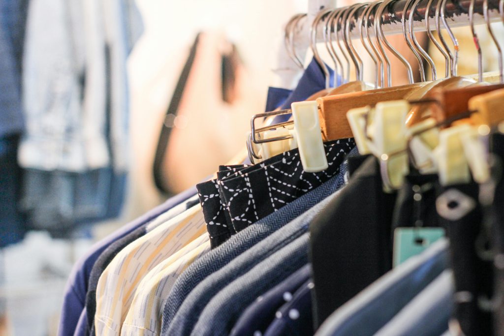 How much does clothing manufacturing cost A vibrant assortment of clothing hanging on racks in a trendy fashion boutique.